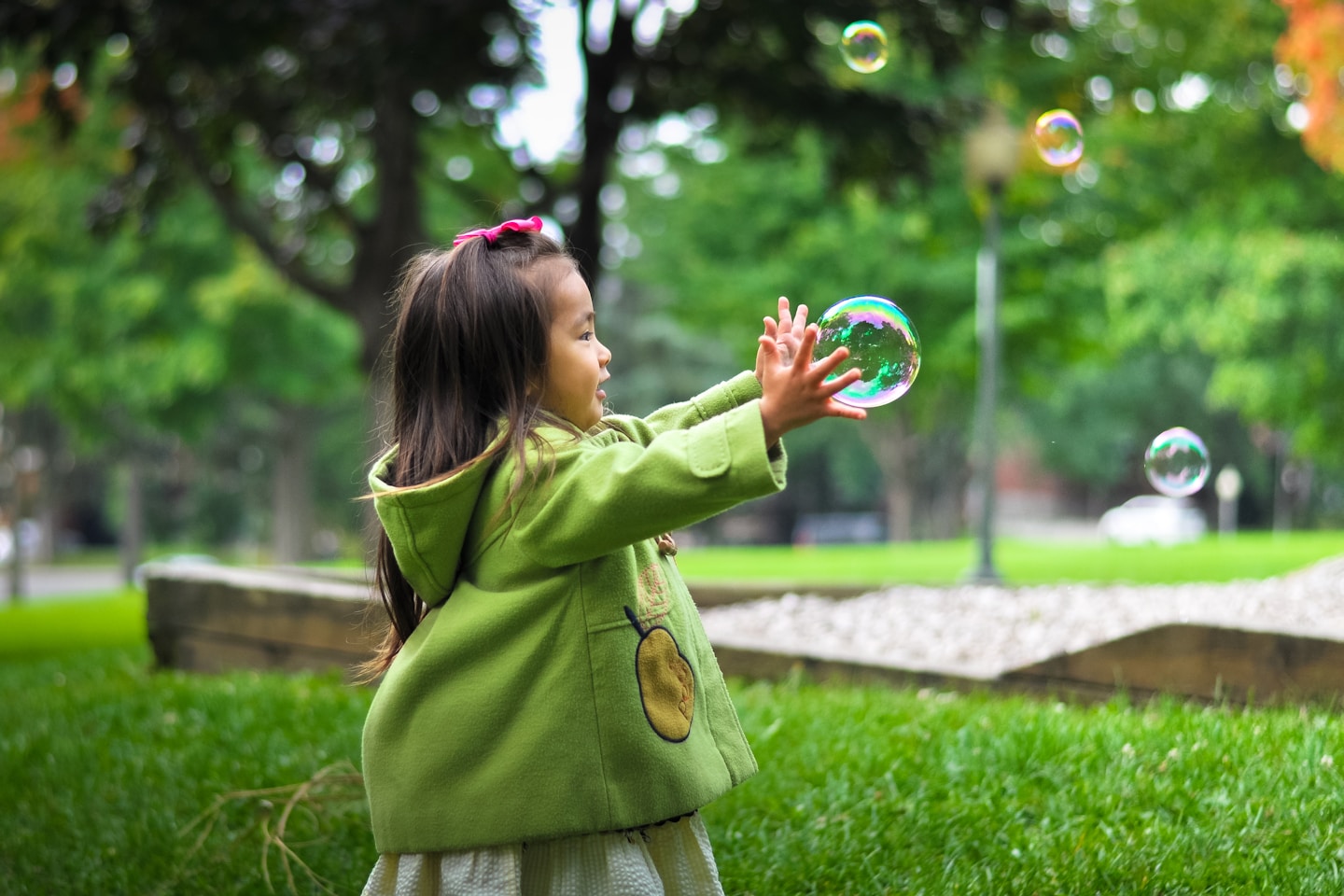 selective photo of a girl holding bubbles